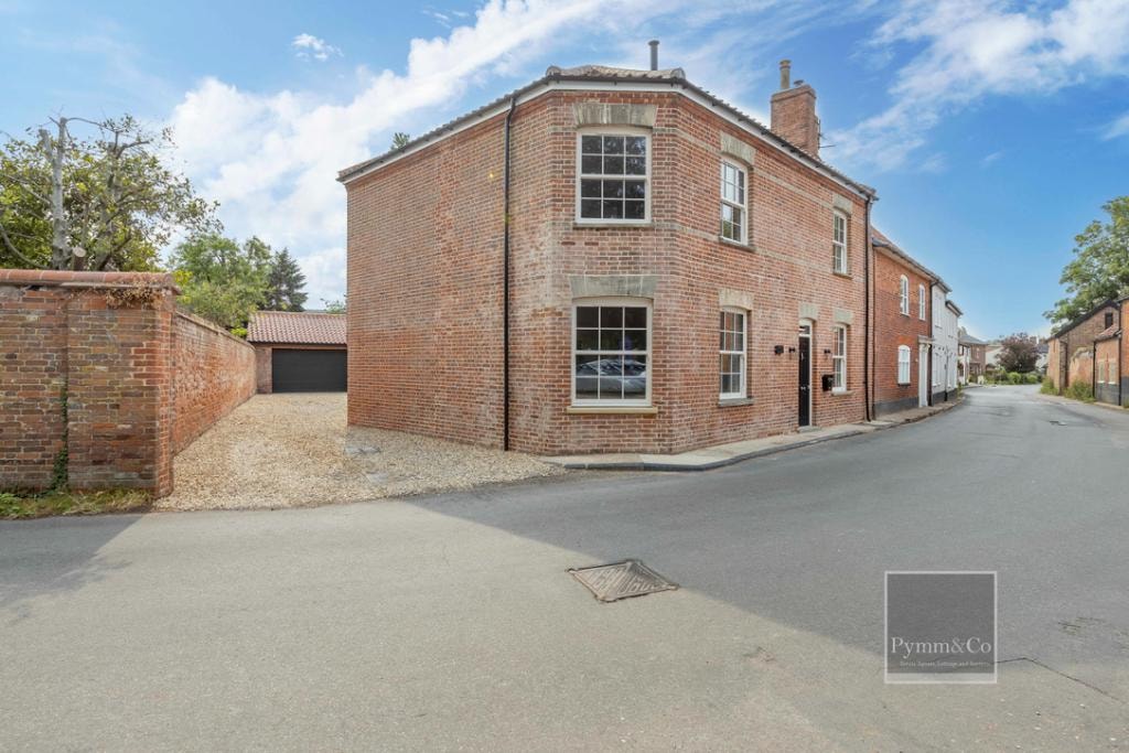 Malthouse refurbishment — corner view showing sash windows, gravel drive and garage