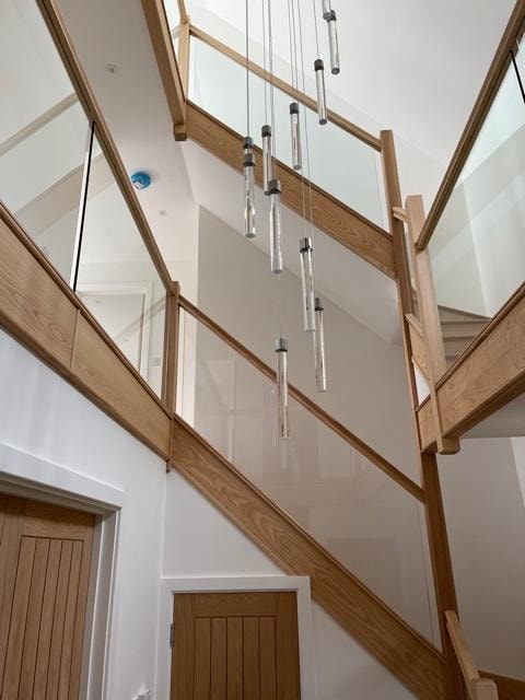 The Nook — oak and glass stairwell with feature pendant lighting